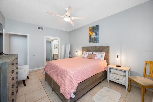 bedroom with light tile patterned floors, visible vents, a ceiling fan, a textured ceiling, and baseboards