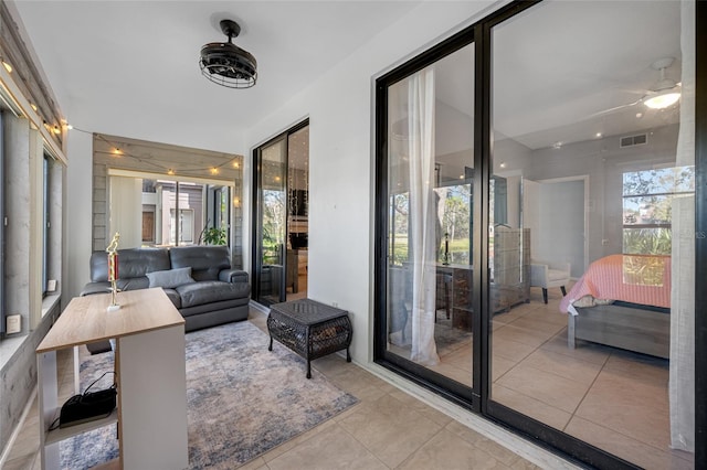 sunroom featuring ceiling fan and visible vents