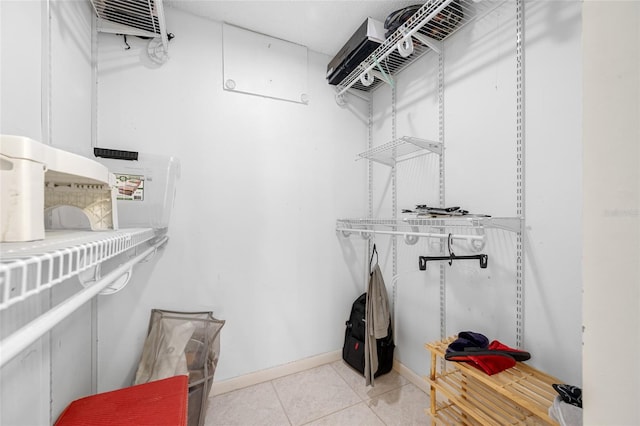 spacious closet with light tile patterned floors