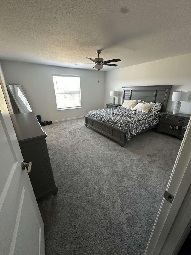 bedroom with baseboards, carpet flooring, a textured ceiling, and ceiling fan