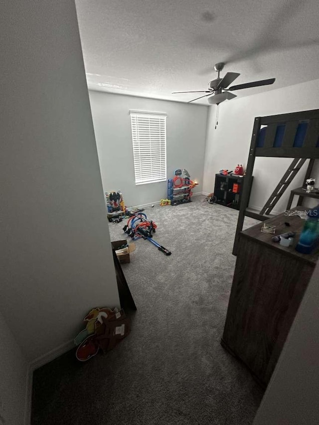 interior space featuring a textured ceiling and a ceiling fan