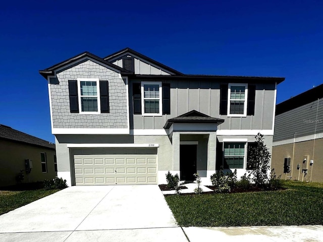 view of front of house featuring board and batten siding, an attached garage, and driveway