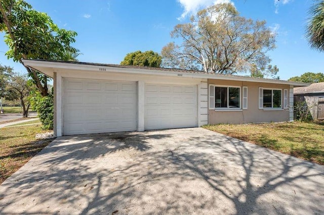 garage with concrete driveway