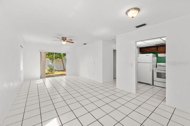 empty room with visible vents, ceiling fan, and light tile patterned flooring