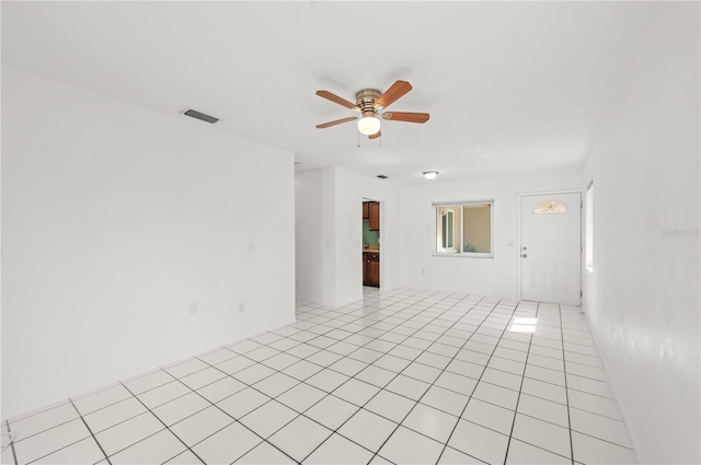 unfurnished room featuring a ceiling fan, visible vents, and light tile patterned floors