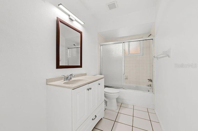 full bath featuring visible vents, toilet, combined bath / shower with glass door, vanity, and tile patterned flooring