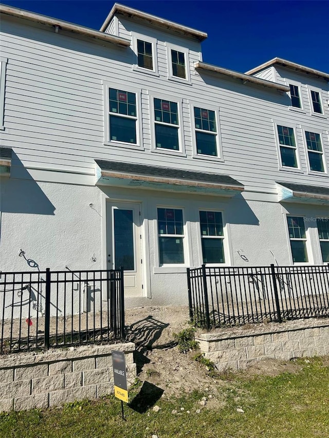 view of front of home with fence