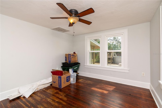 empty room featuring baseboards, visible vents, ceiling fan, hardwood / wood-style floors, and a textured ceiling