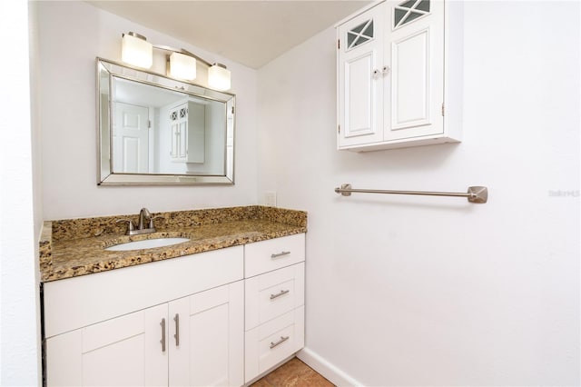 bathroom with baseboards and vanity