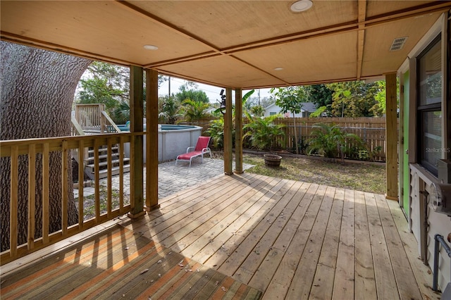 wooden deck featuring a fenced backyard, visible vents, and a patio