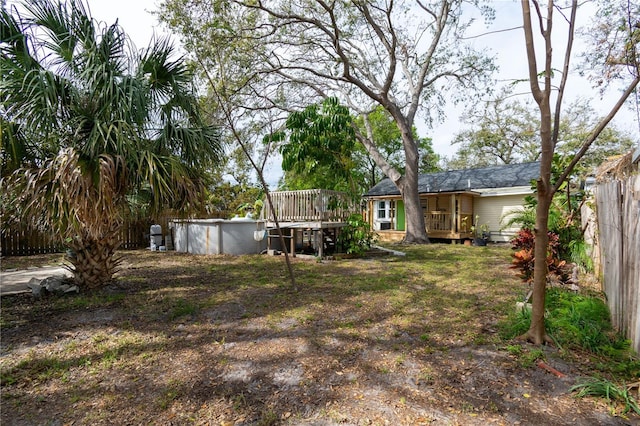 view of yard with a wooden deck and fence