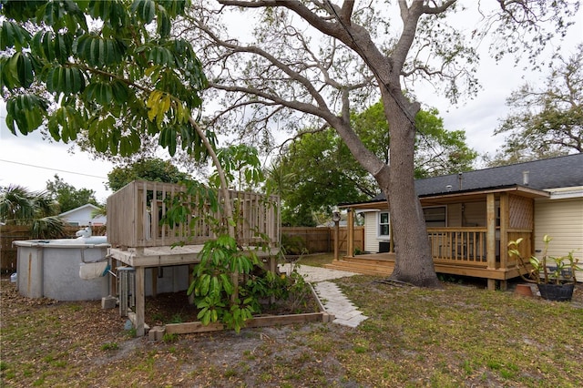 view of yard with fence and a deck