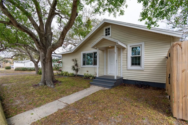 bungalow-style home featuring fence