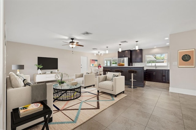 living room featuring light tile patterned floors, recessed lighting, visible vents, ceiling fan, and baseboards