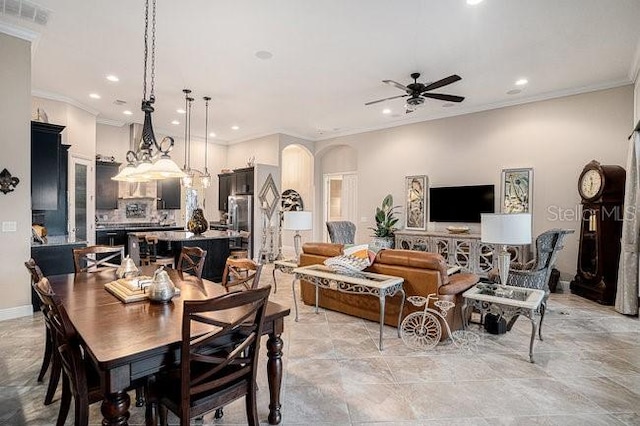 dining space featuring arched walkways, recessed lighting, visible vents, ornamental molding, and ceiling fan