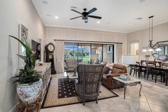 living room with visible vents, ornamental molding, tile patterned flooring, and ceiling fan with notable chandelier