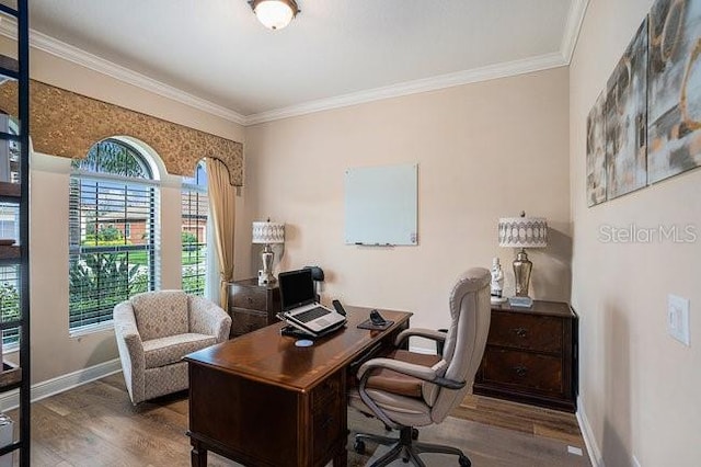 home office featuring crown molding, baseboards, and wood finished floors