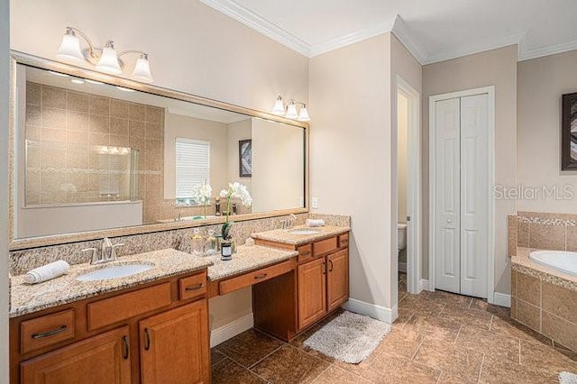 bathroom featuring double vanity, a garden tub, ornamental molding, and a sink