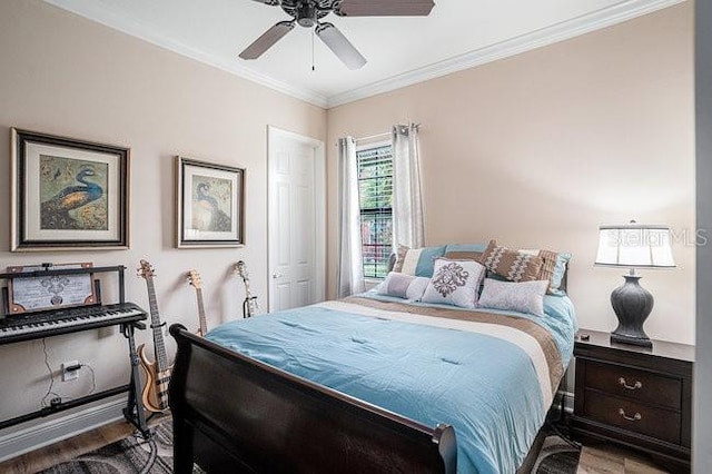 bedroom with wood finished floors, a ceiling fan, and crown molding