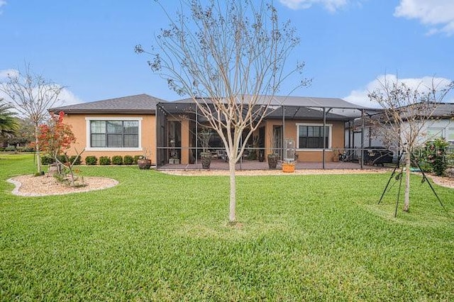 back of property with a lanai, a lawn, and stucco siding