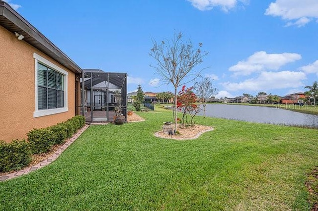 view of yard with a water view and a lanai