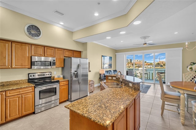 kitchen featuring a sink, visible vents, ornamental molding, appliances with stainless steel finishes, and brown cabinets