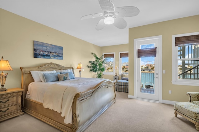 carpeted bedroom with baseboards, ceiling fan, and access to exterior