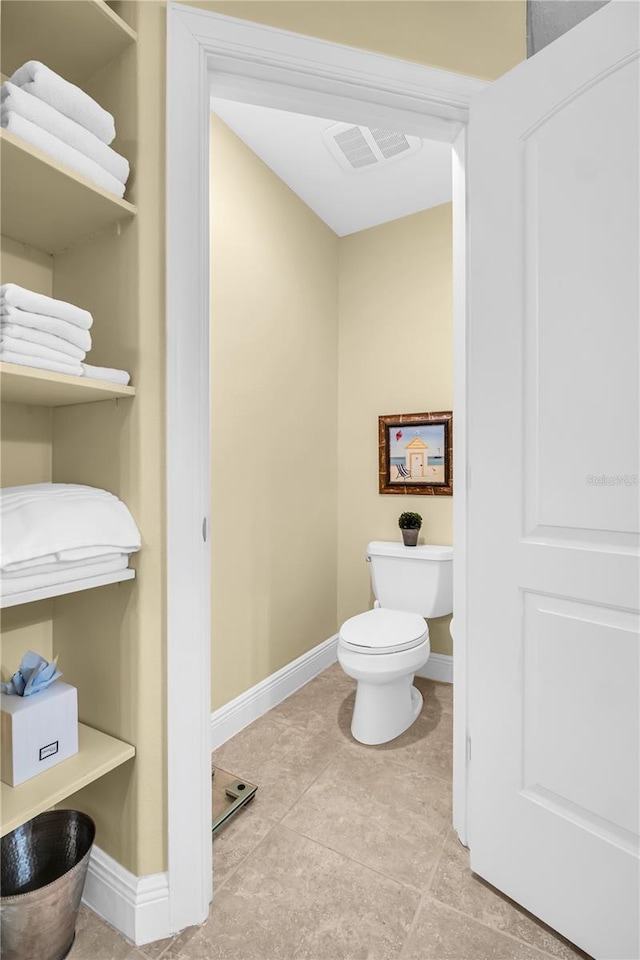 bathroom with toilet, visible vents, baseboards, and tile patterned flooring