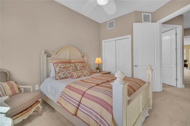 bedroom featuring ceiling fan, visible vents, a closet, and light colored carpet