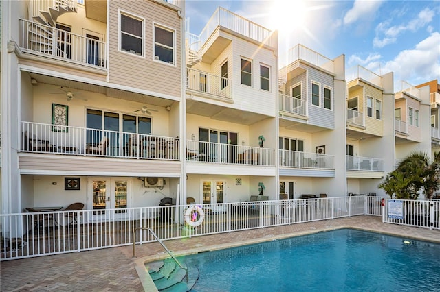 community pool featuring fence and a residential view