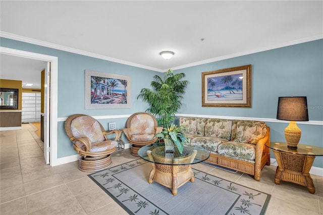 sitting room featuring baseboards, ornamental molding, and tile patterned floors