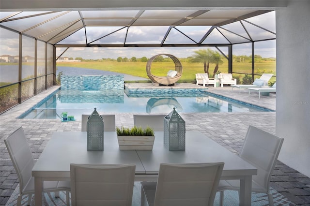 pool featuring a patio, outdoor dining space, and glass enclosure