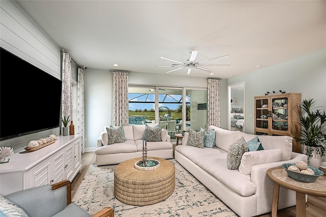 living room featuring ceiling fan, baseboards, wood finished floors, and recessed lighting