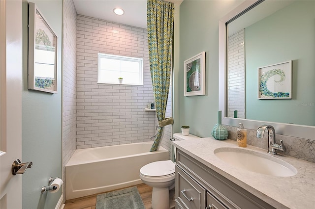 full bath with toilet, shower / tub combination, wood finished floors, and vanity