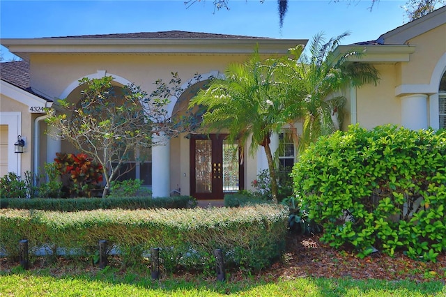 doorway to property featuring stucco siding