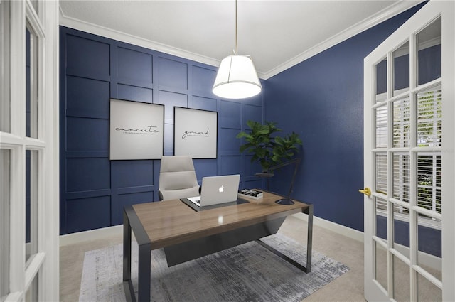 home office featuring crown molding, light colored carpet, a decorative wall, and baseboards