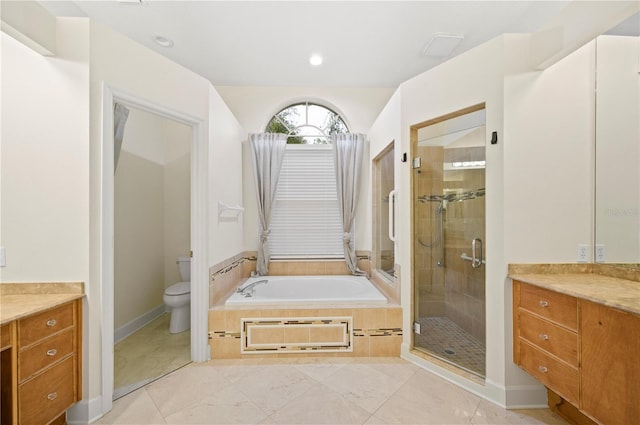 full bath with a shower stall, a garden tub, vanity, and toilet