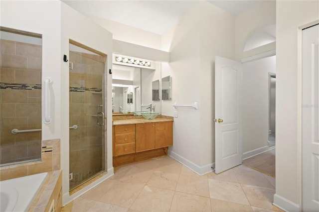 full bath with a stall shower, baseboards, a garden tub, tile patterned flooring, and vanity