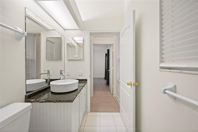 bathroom with vanity, toilet, and tile patterned floors