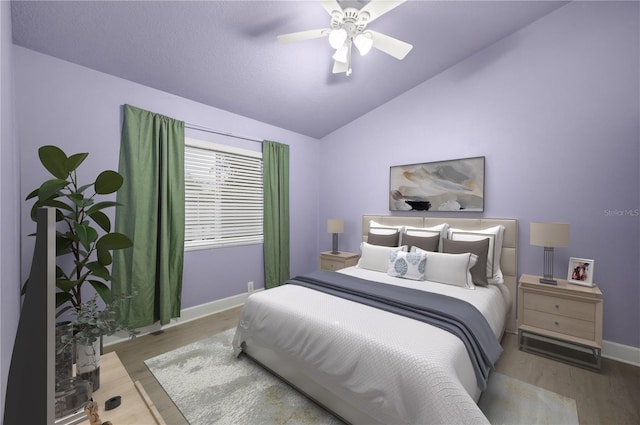 bedroom with vaulted ceiling, wood finished floors, a ceiling fan, and baseboards