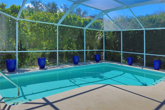 outdoor pool featuring a patio area and a lanai