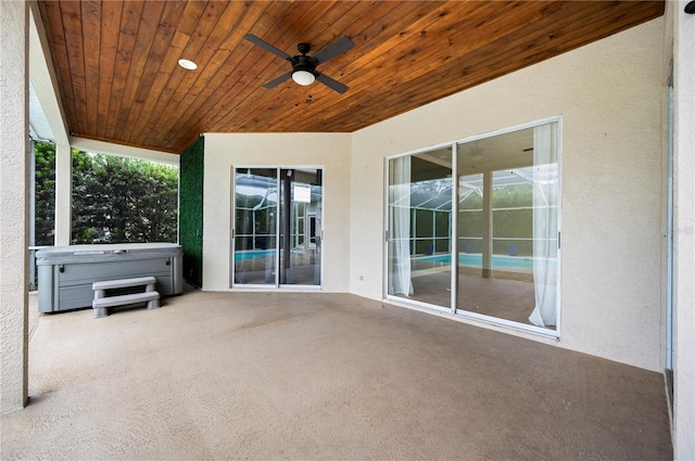 view of patio with a ceiling fan and a hot tub