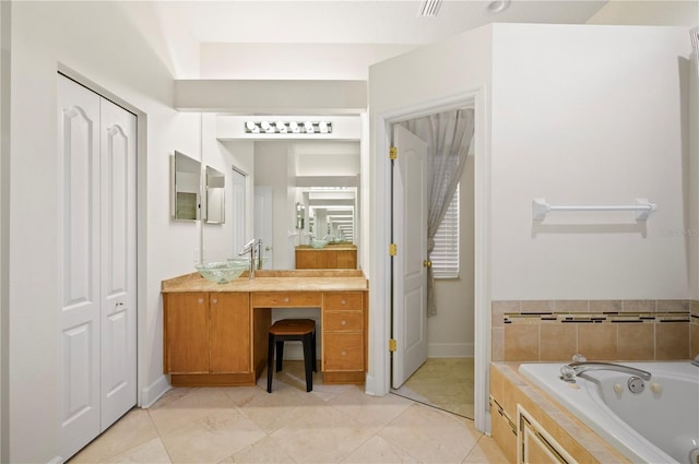 full bath featuring a closet, vanity, and a bath