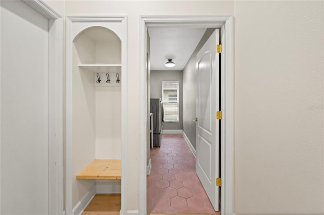 mudroom with baseboards and tile patterned floors