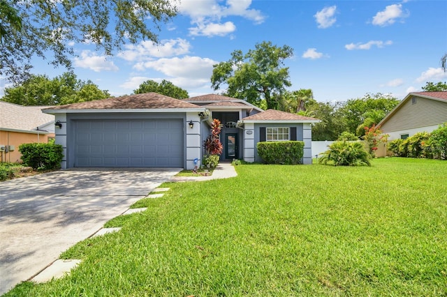 single story home with driveway, a front lawn, an attached garage, and stucco siding