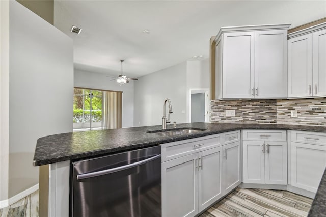 kitchen featuring tasteful backsplash, visible vents, a ceiling fan, a sink, and dishwasher