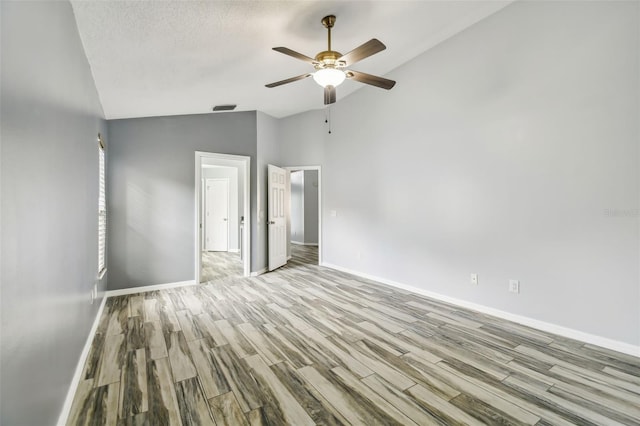 unfurnished bedroom with baseboards, a textured ceiling, visible vents, and wood finished floors