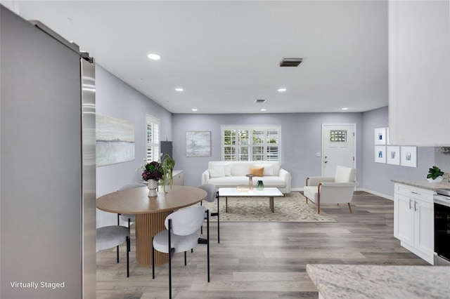 dining area with recessed lighting, visible vents, and wood finished floors