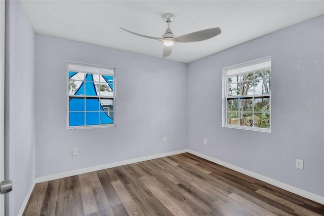 unfurnished room featuring a ceiling fan, baseboards, and wood finished floors