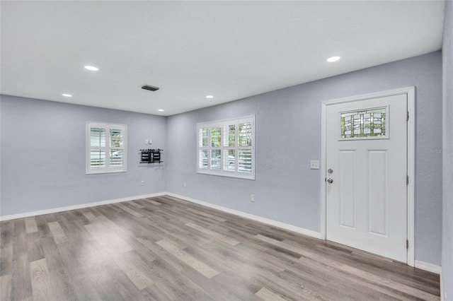 foyer entrance with recessed lighting, visible vents, baseboards, and wood finished floors